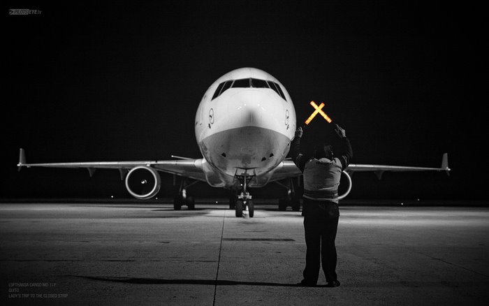 Lufthansa Cargo MD-11F aircraft marshaler at night