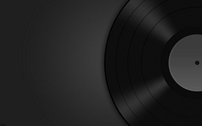 Minimalist black vinyl record on dark background