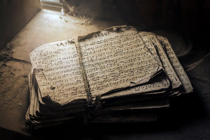 Stack of old sheet music tied with string