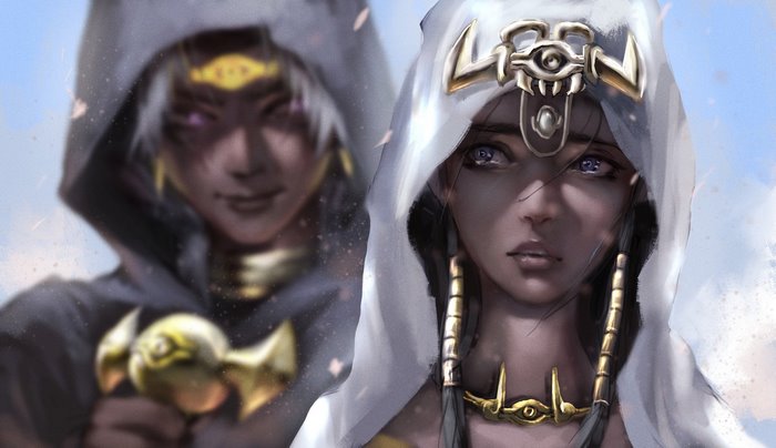 Two women in hooded cloaks with Egyptian-inspired jewelry