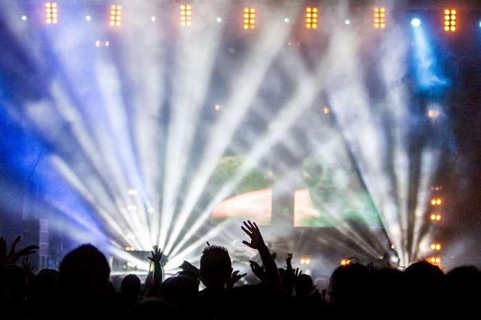 Concert crowd with spotlights and smoke