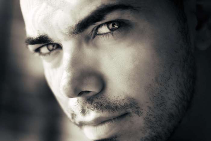 Man with beard and intense gaze, black and white portrait