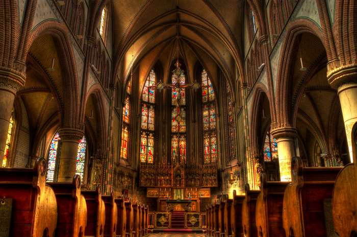 Interior of a grand church with stained glass windows