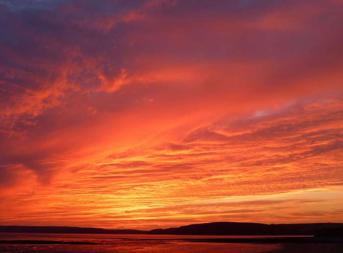 Dramatic sunset over water in Wales 4K