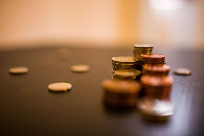 Stacks of coins on a dark surface, 4K