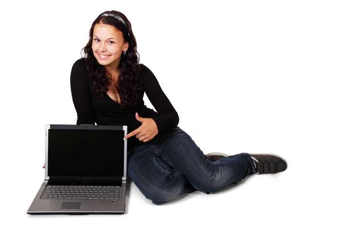 Young woman pointing at a laptop