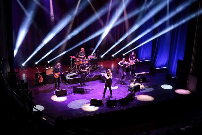 Band performing live concert on stage with lighting