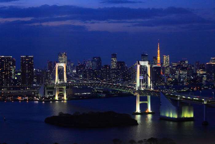 Tokyo cityscape with Rainbow Bridge and Tokyo Tower at night