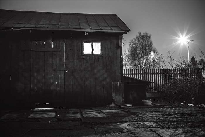 Dark wooden workshop with light in window at night 4K