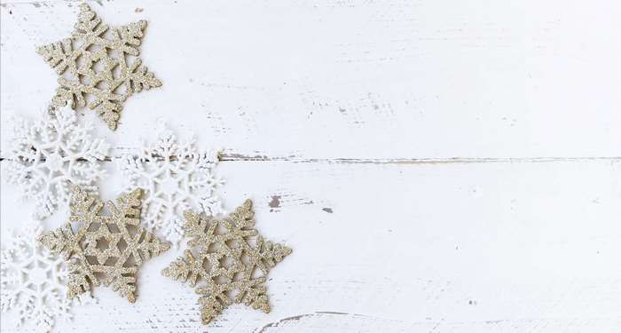 Christmas snowflakes on a white wooden surface