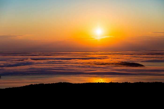 Sunrise over fog-covered ocean in Acadia National Park, Maine