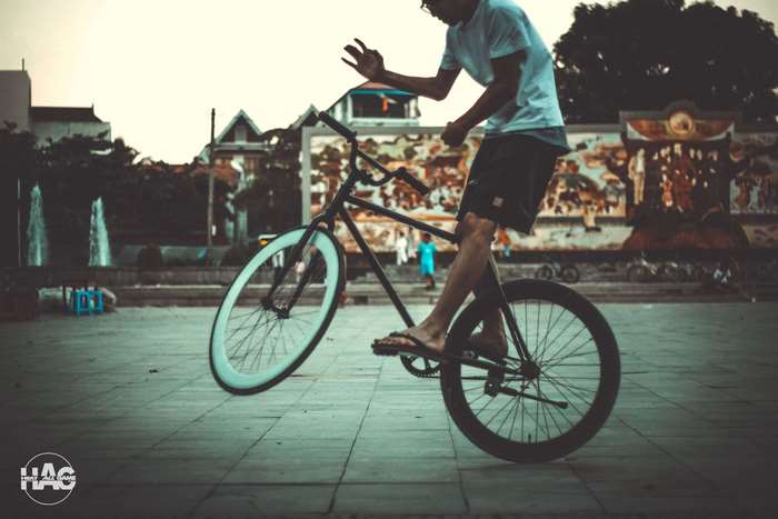 Man performing a trick on a fixed gear bicycle