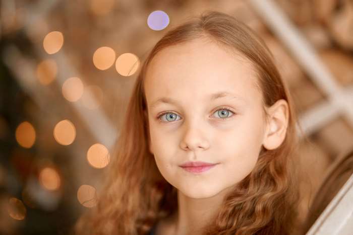 Portrait of a Smiling Young Girl with Curly Hair