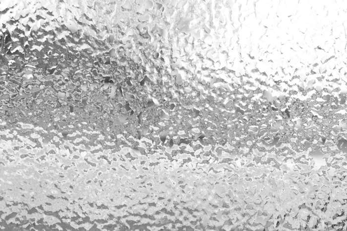Frozen window with ice and rain
