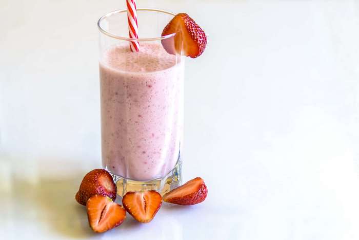 Strawberry Smoothie in a Glass with Strawberries 4K