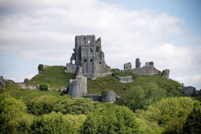 Corfe Castle ruins on a grassy hill