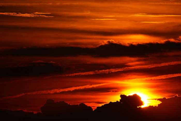 Sunset with dark clouds and sunbeams 4K