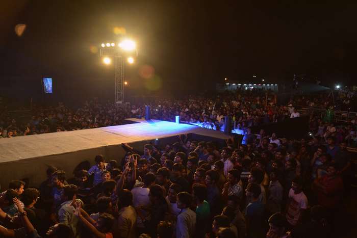 Crowd at a concert venue with a stage