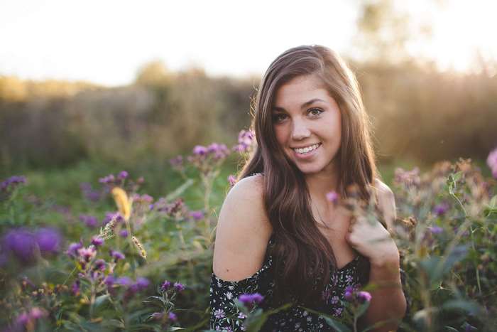Pretty girl smiling in a field of purple flowers