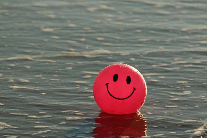 Pink smiley ball on the ocean