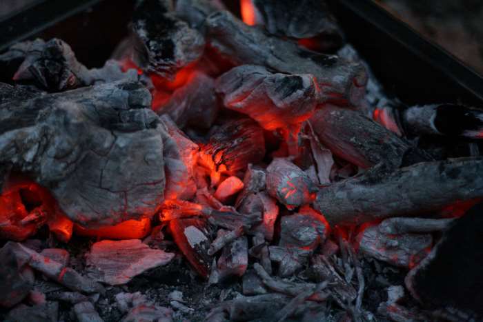 Glowing hot coals and embers in a fire pit