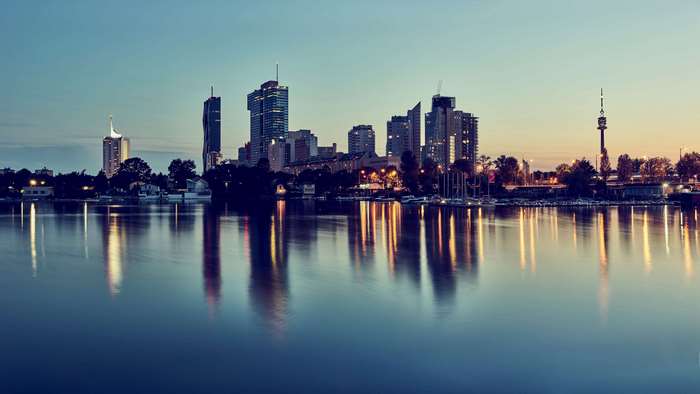 Cityscape with skyscrapers and river at dusk