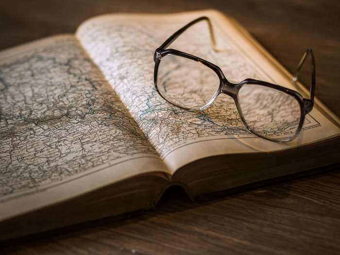 Eyeglasses on an open map book