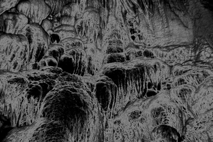 Solarized cave with stalactites and mineral formations