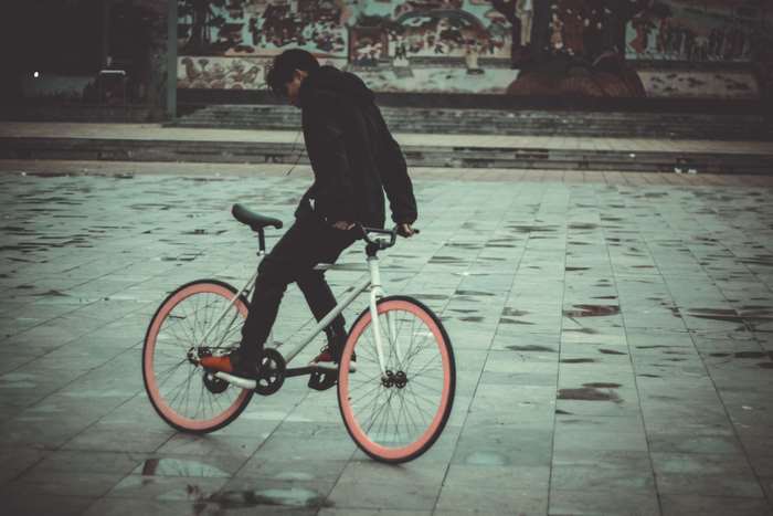 Person riding a fixed gear bicycle in a square