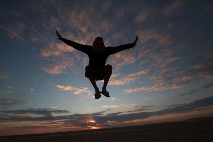Man jumping at sunset in Egypt