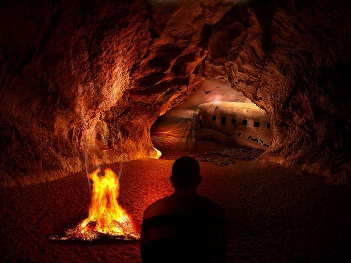 Man in cave with fire and airplane wreck