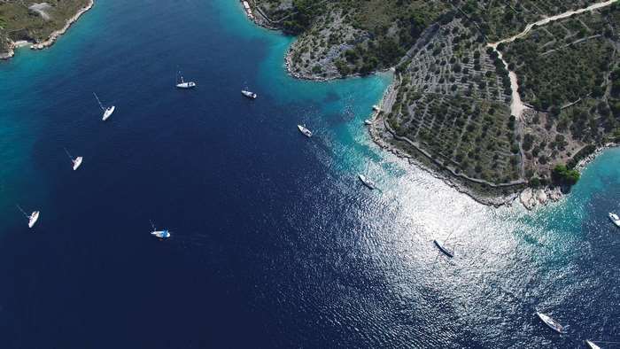 Aerial view of sailboats in a Mediterranean bay