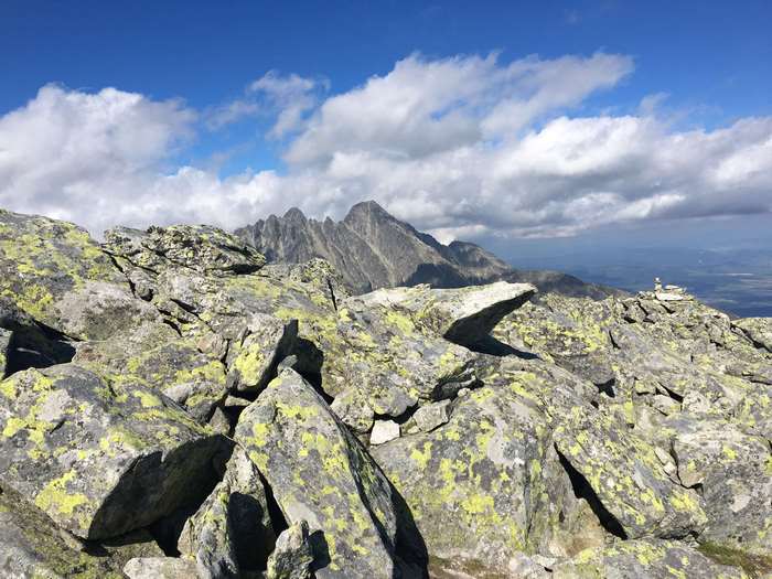 Rocky mountain peak with clouds and distant landscape