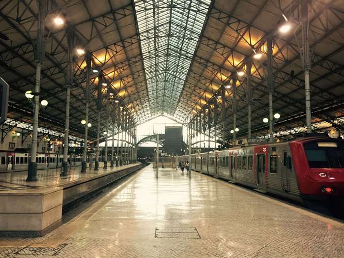Train station interior with train on platform