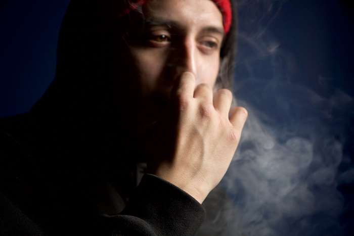 Man smoking with smoke around his face