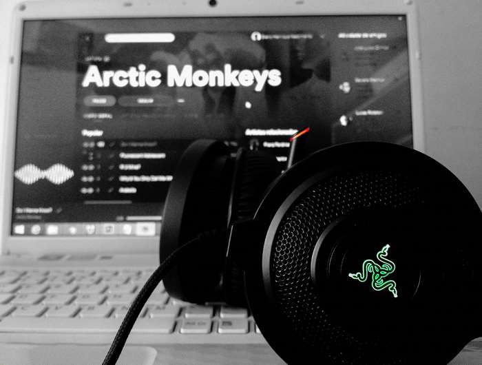 Arctic Monkeys music on laptop with Razer headset