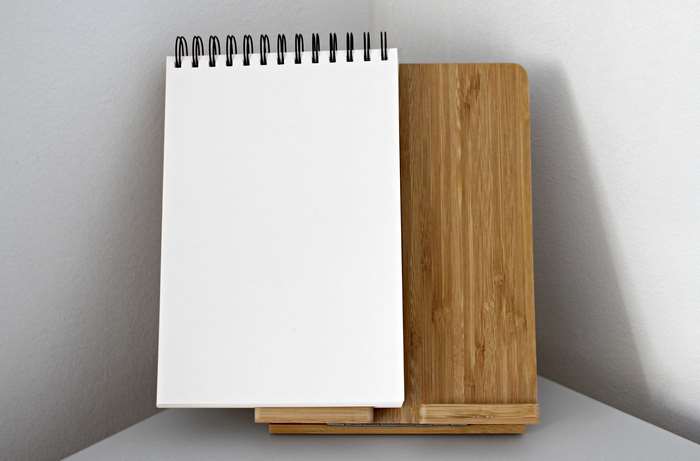 Blank spiral notebook on a wooden stand