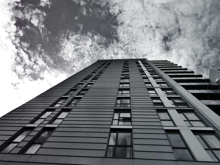 Modern building with glass windows against cloudy sky