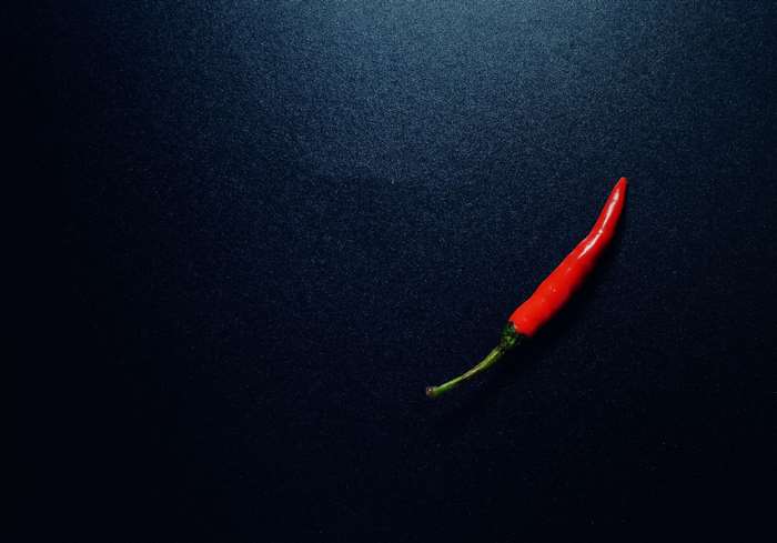 Red chili pepper on a dark surface