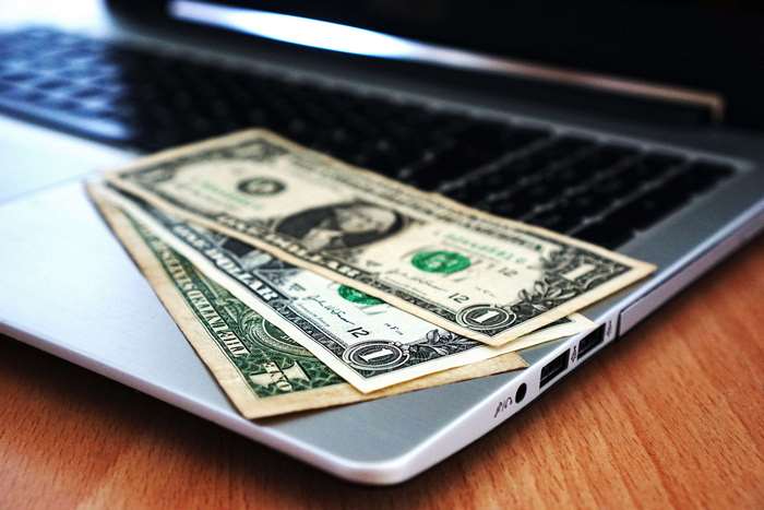 Dollar Bills on Laptop Keyboard