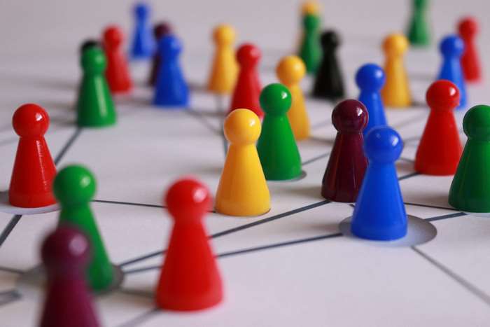 Colorful game pawns on a networked board