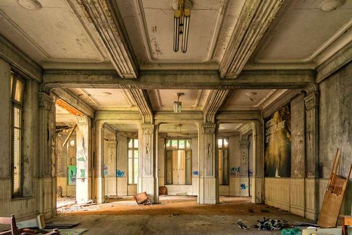 Abandoned luxury hotel hall with graffiti
