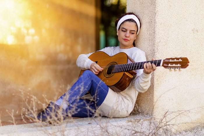 Woman playing guitar outdoors