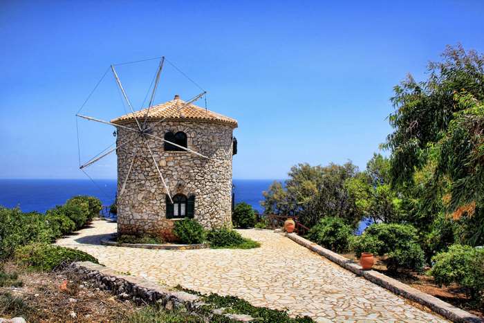 Stone windmill on a cliff overlooking the sea in Zakynthos, Greece