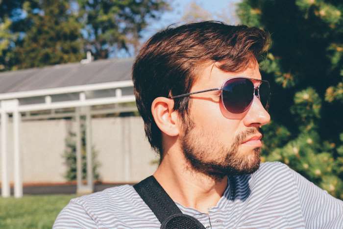 Man with sunglasses outdoors on a sunny day