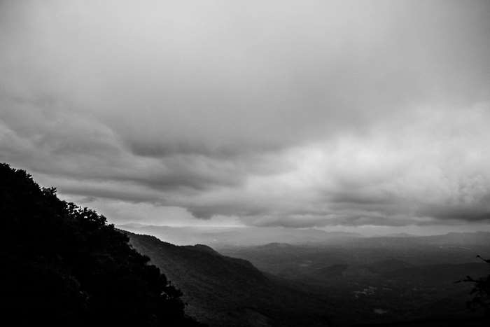 Black and white landscape of rolling hills and clouds