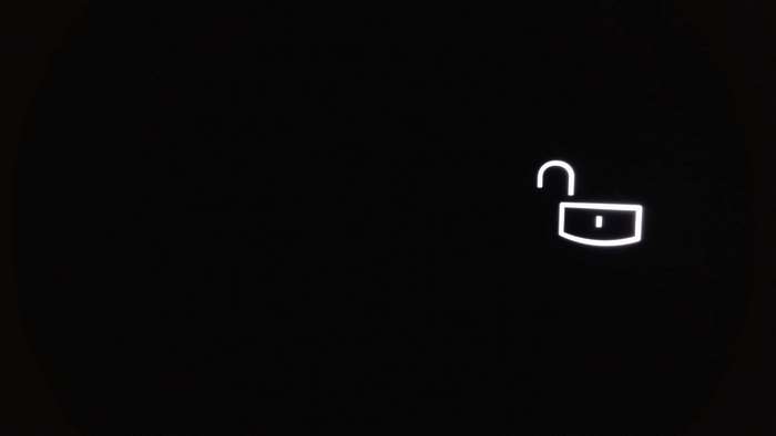 Unlocked padlock icon on black background