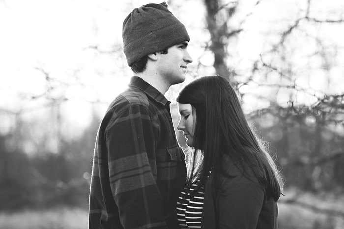 Couple in beanies and plaid shirt outdoors