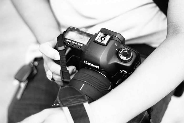 Person holding a Canon EOS digital camera