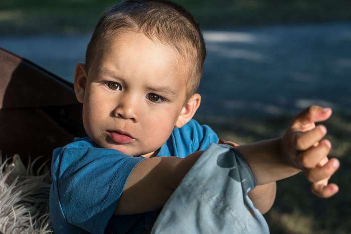 Young boy with brown eyes and blue shirt